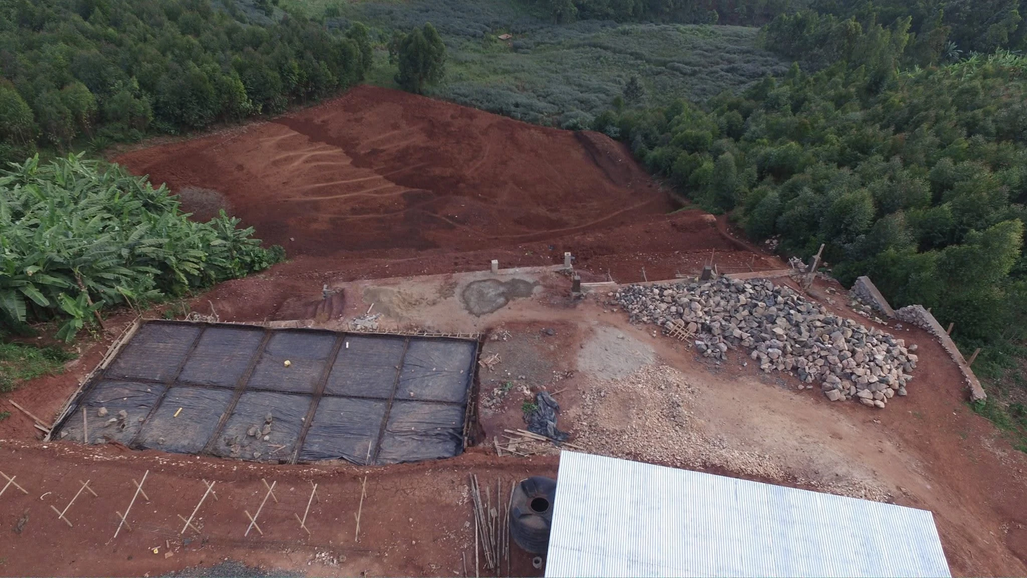 Second original drone view of Connection Hotel hillside earthworks, construction materials and early structural works